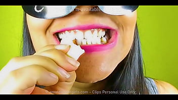 Girl with beautiful teeth crumpled chewed up candy chewing gum nuts to mud chew videos, look her very close in her mouth